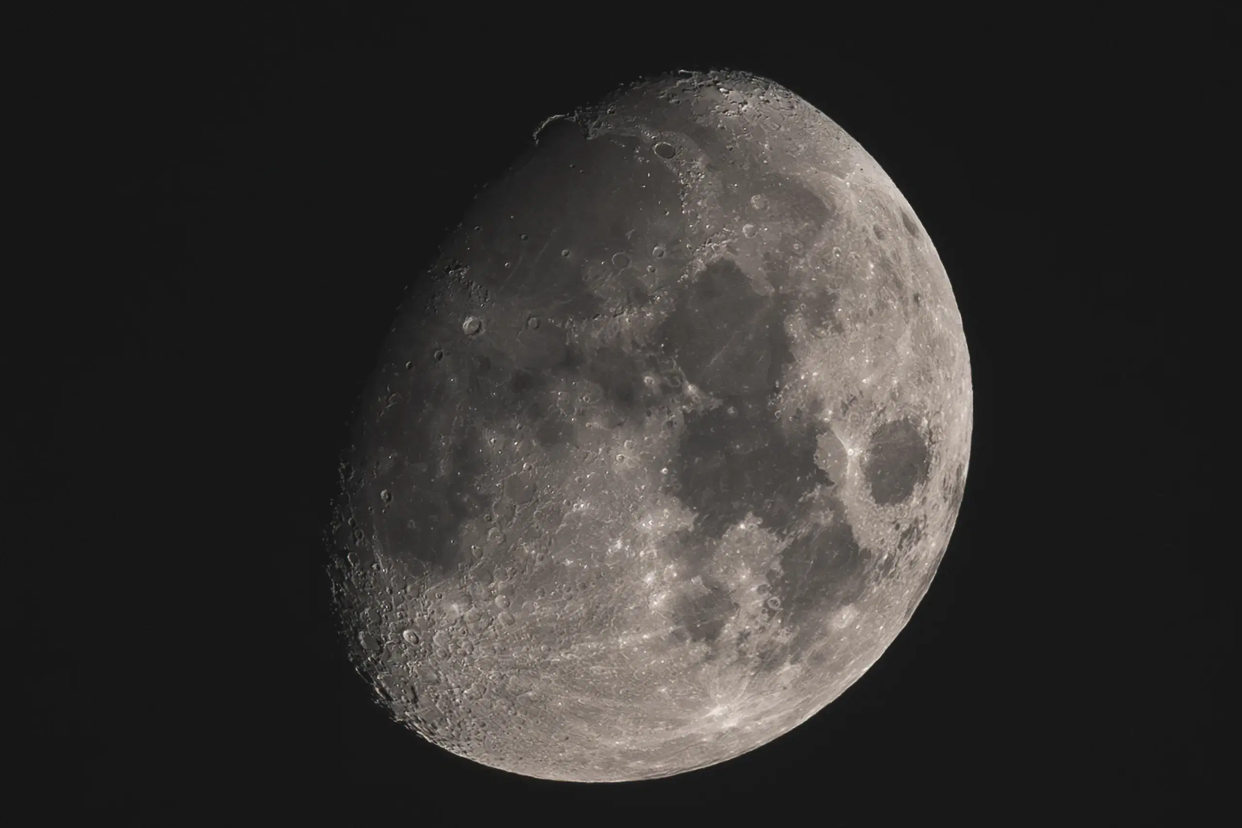 A waxing gibbous moon against black sky, craters sharp along the terminator.